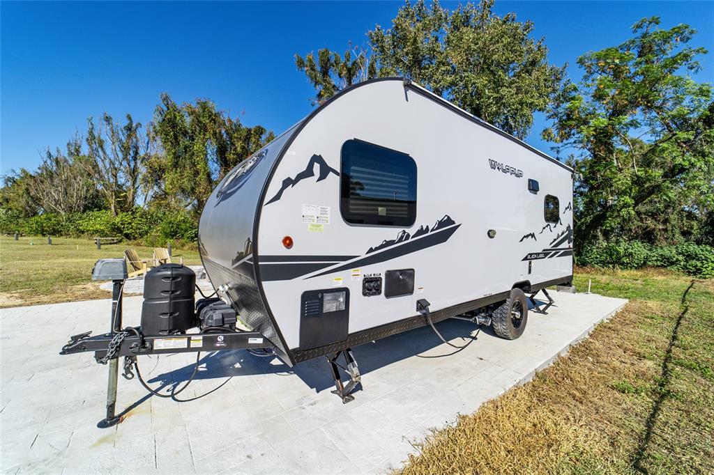 15991 Northeast 243rd Place Road, Unit 351 & 352 Fort McCoy, FL 32134 - Photo 60 of 86 a view of a white house with a yard and sitting area