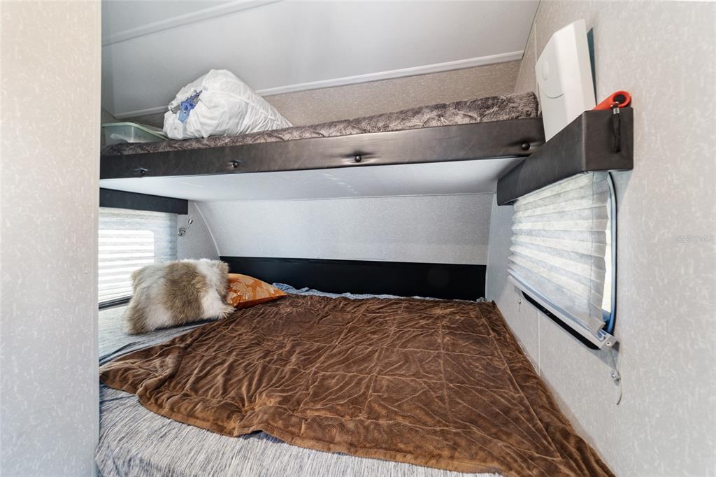 15991 Northeast 243rd Place Road, Unit 351 & 352 Fort McCoy, FL 32134 - Photo 63 of 86 a bedroom with a bed and chair