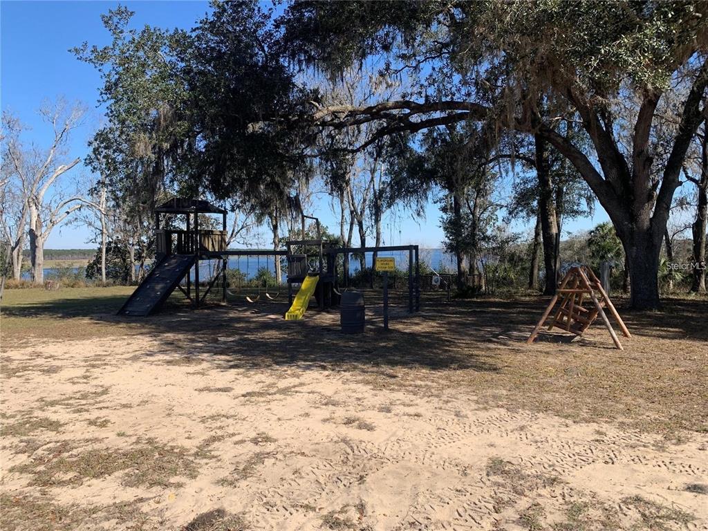 15991 Northeast 243rd Place Road, Unit 351 & 352 Fort McCoy, FL 32134 - Photo 81 of 86 a view of outdoor space with playground and green space