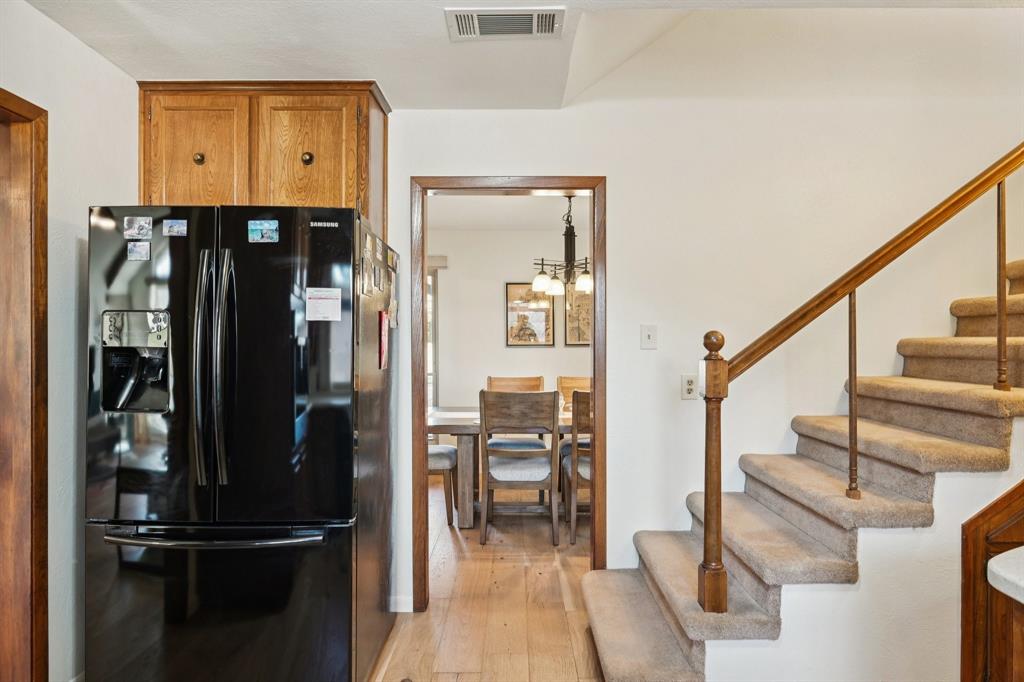 840 Ridge Drive Bedford, TX 76021 - Photo 13 of 40 A view of the kitchen and the stairs lead to the game room, office and half bath.