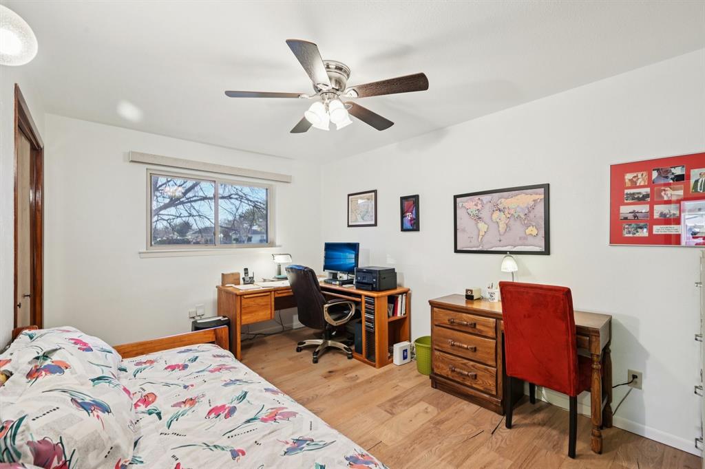 840 Ridge Drive Bedford, TX 76021 - Photo 29 of 40 One of the bedrooms on the main floor, with a ceiling fan, engineered wood floors, and a closet.