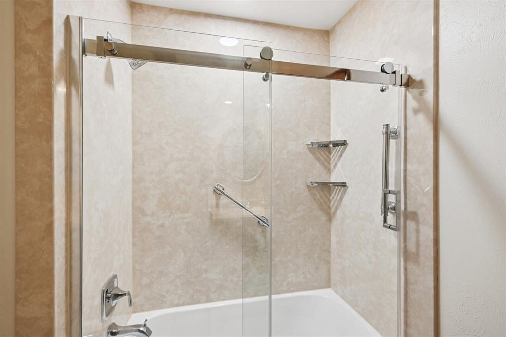 840 Ridge Drive Bedford, TX 76021 - Photo 32 of 40 Primary bathroom with an updated walk in shower.