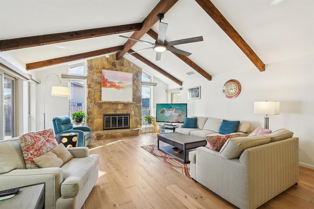 840 Ridge Drive Bedford, TX 76021 - Photo 4 of 40 Living room with an engineered wood floor, vaulted ceiling, floor to ceiling stone fireplace and remote control, motorized shades.