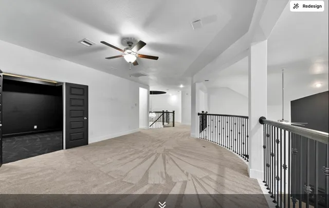 a view of a bedroom with wooden floor and a ceiling fan