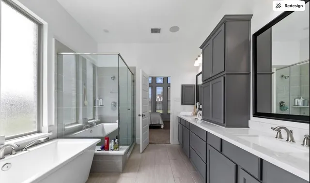 a bathroom with a tub a sink and mirror