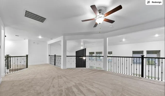 a view of a kitchen with a stove and a ceiling fan