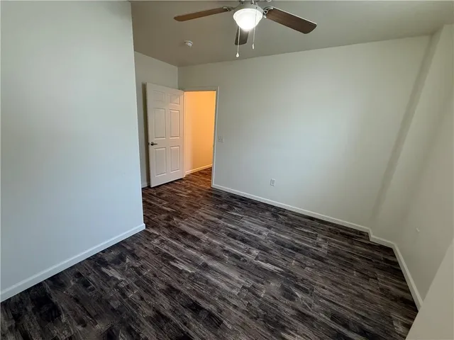 a view of an empty room and wooden floor