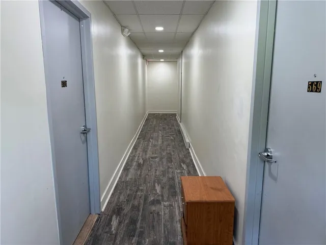 a view of hallway with wooden floor