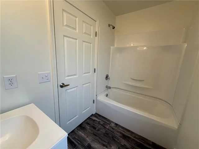 a bathroom with a bathtub and a sink