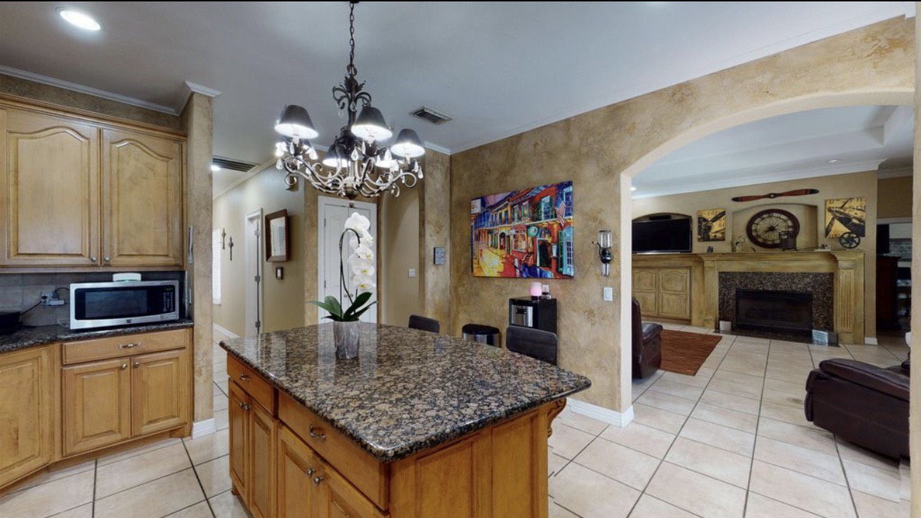 104 Mockingbird Lane Bridge City, TX 77611 - Photo 15 of 27 a dining hall with a sink and a fireplace