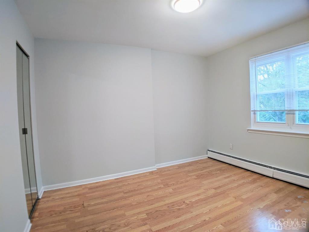 B Alva Court Edison, NJ 08817 - Photo 11 of 17 wooden floor in an empty room with a window