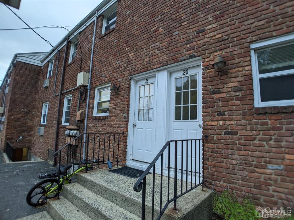 B Alva Court Edison, NJ 08817 - Photo 15 of 17 a view of a brick house with stairs and wooden fence