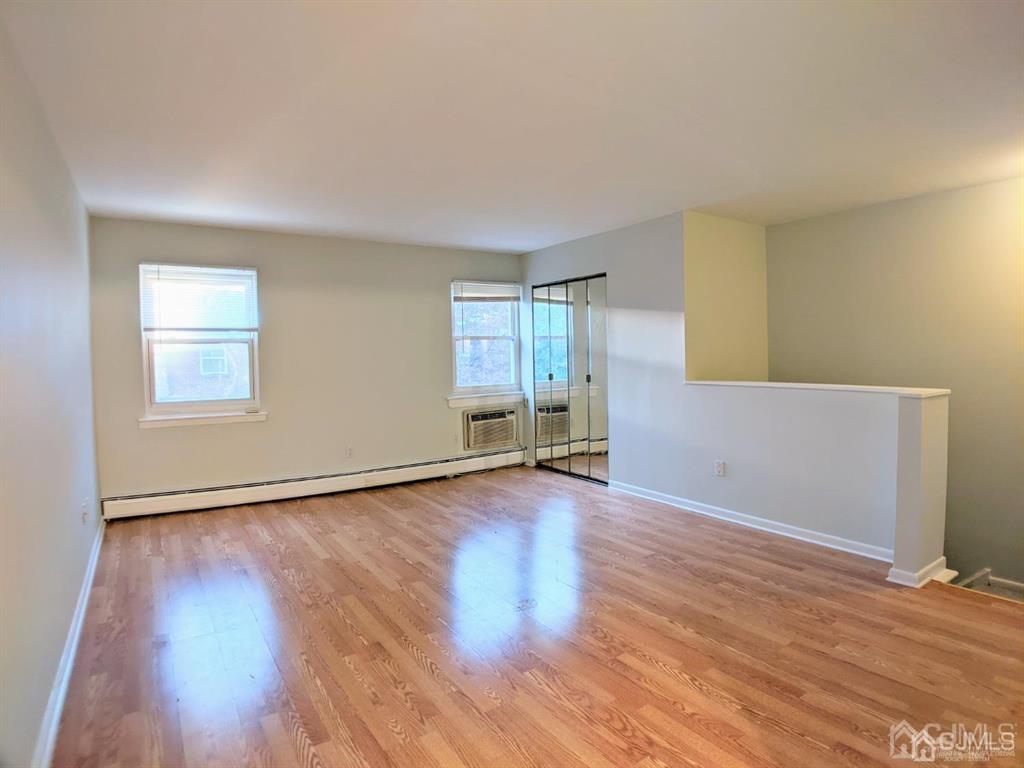 B Alva Court Edison, NJ 08817 - Photo 3 of 17 a view of an empty room with wooden floor and a window