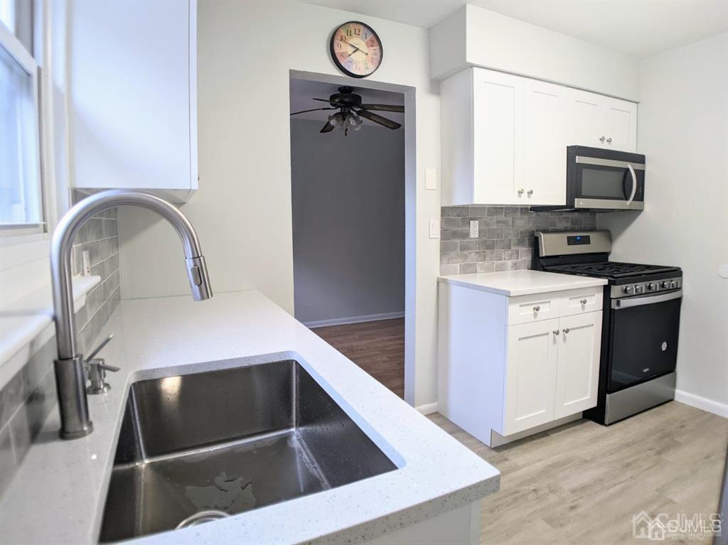 B Alva Court Edison, NJ 08817 - Photo 5 of 17 a kitchen with a refrigerator sink and cabinets