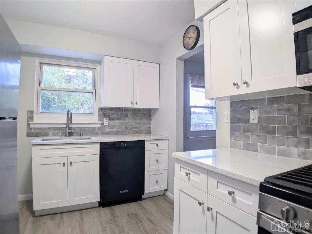 B Alva Court Edison, NJ 08817 - Photo 7 of 17 a kitchen with granite countertop white cabinets and white appliances