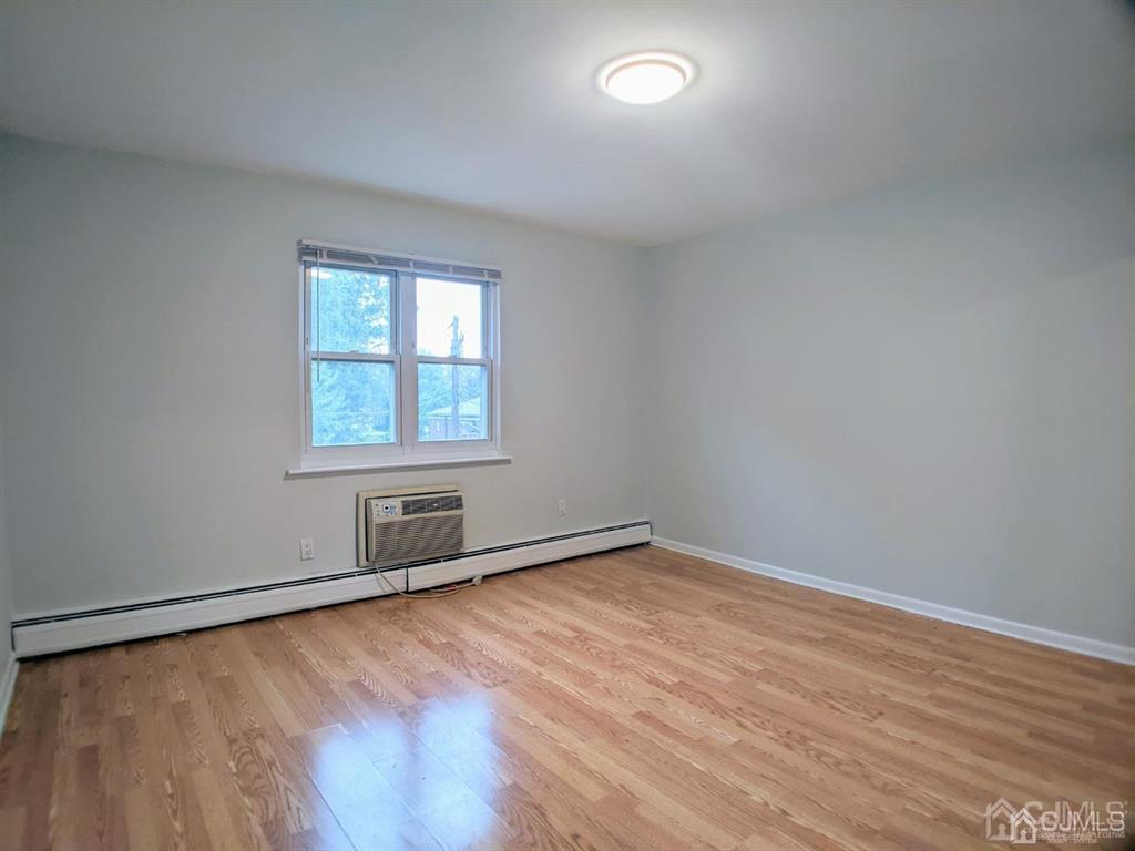 B Alva Court Edison, NJ 08817 - Photo 9 of 17 an empty room with wooden floor and windows