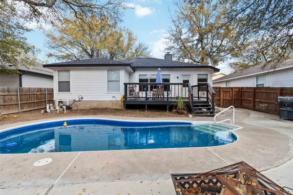 a view of a house with swimming pool and sitting area