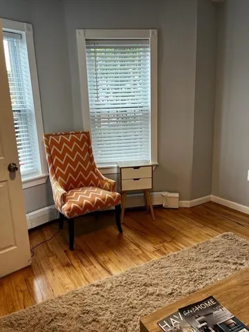 a living room with a couch and next to a window