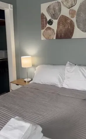 a bedroom with a bed and lamp