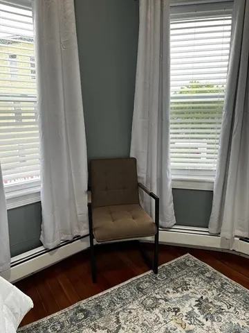 a bathroom with a sink a toilet and a window