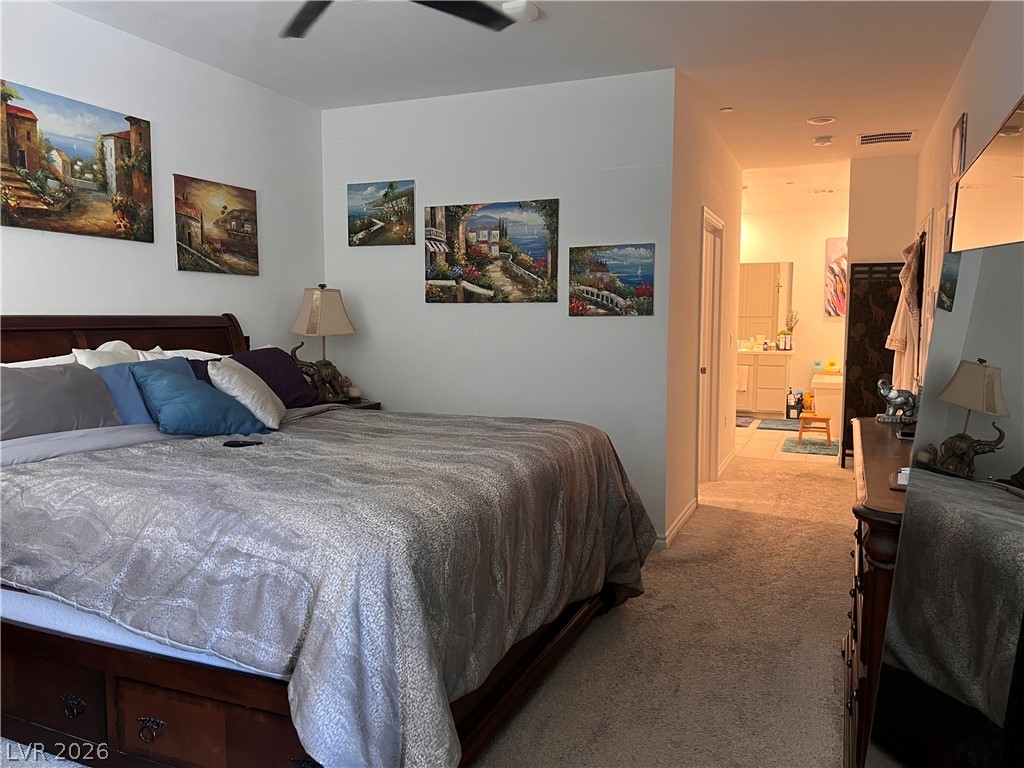 2555 Hampton Road, Unit 2207 Henderson, NV 89052 - Photo 26 of 34 Unwind in a comfortable bedroom featuring soft carpeting and a glimpse into an adjoining bathroom.