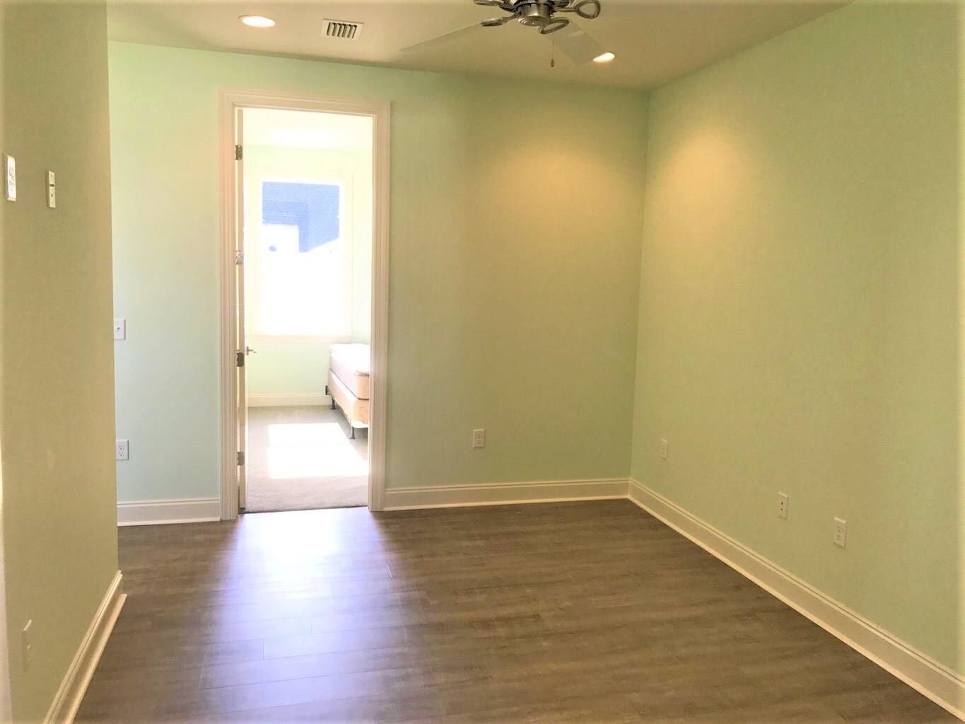148 Chapman Street Santa Rosa Beach, FL 32459 - Photo 12 of 23 a view of a room with wooden floor and a bathroom