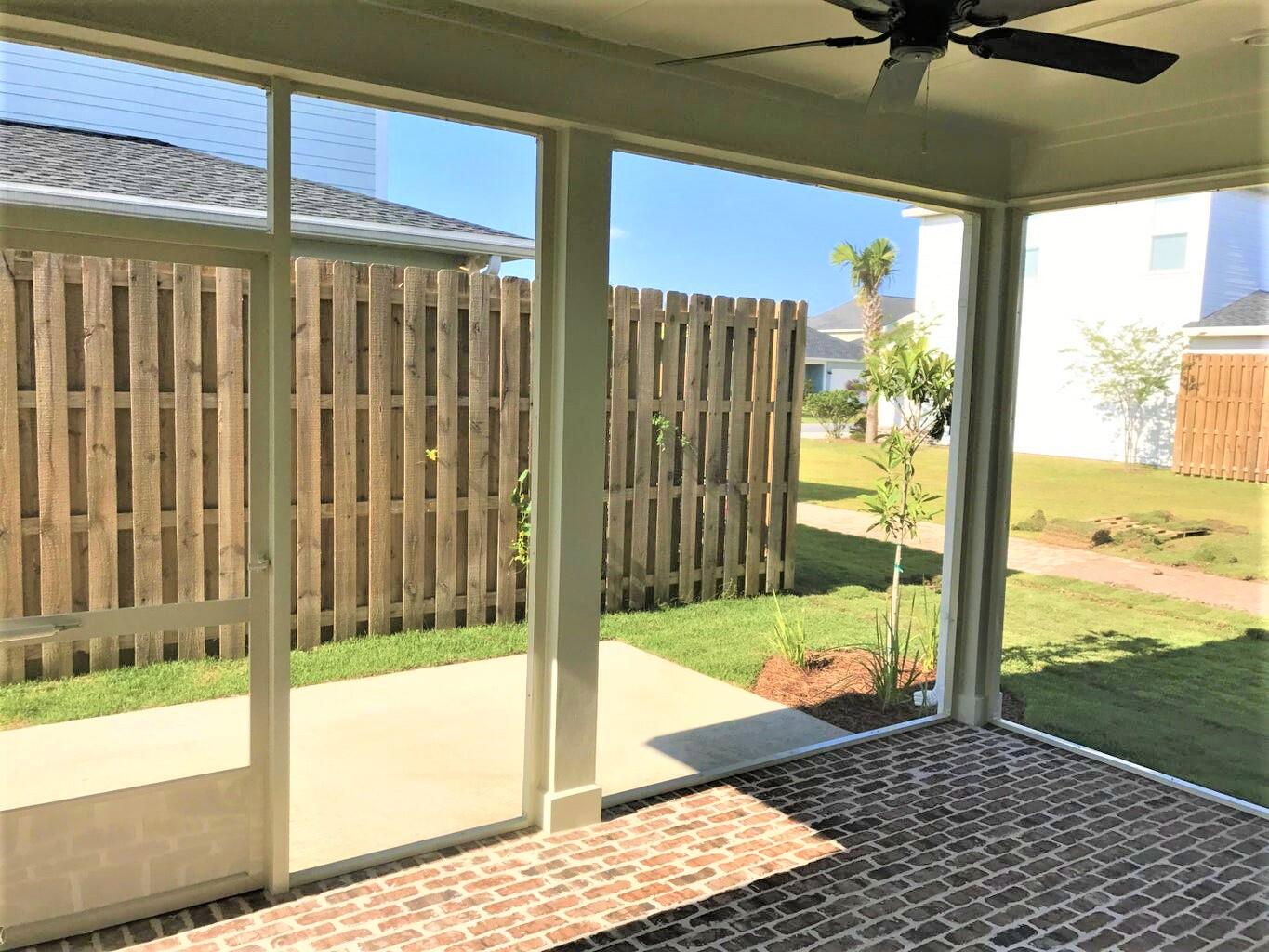 148 Chapman Street Santa Rosa Beach, FL 32459 - Photo 14 of 23 a view of a glass door with a floor to ceiling window next to a yard