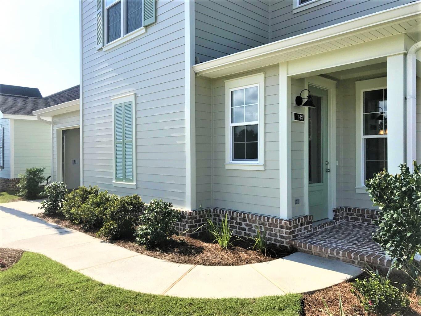 148 Chapman Street Santa Rosa Beach, FL 32459 - Photo 3 of 23 a front view of a house with garden