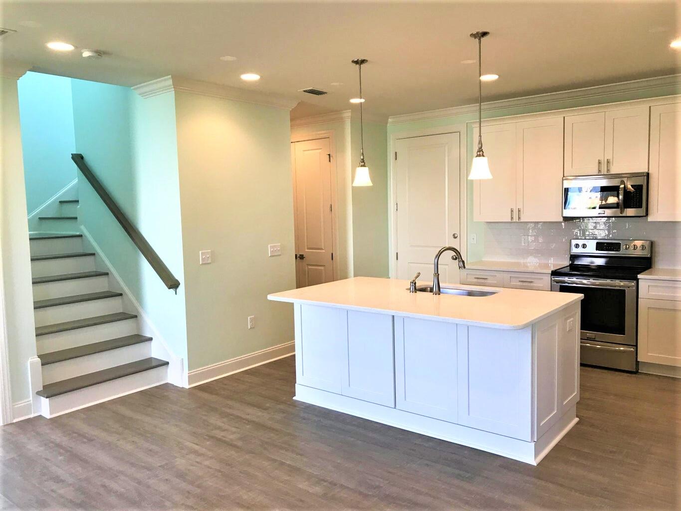 148 Chapman Street Santa Rosa Beach, FL 32459 - Photo 6 of 23 a kitchen with stainless steel appliances granite countertop a sink a stove and a refrigerator
