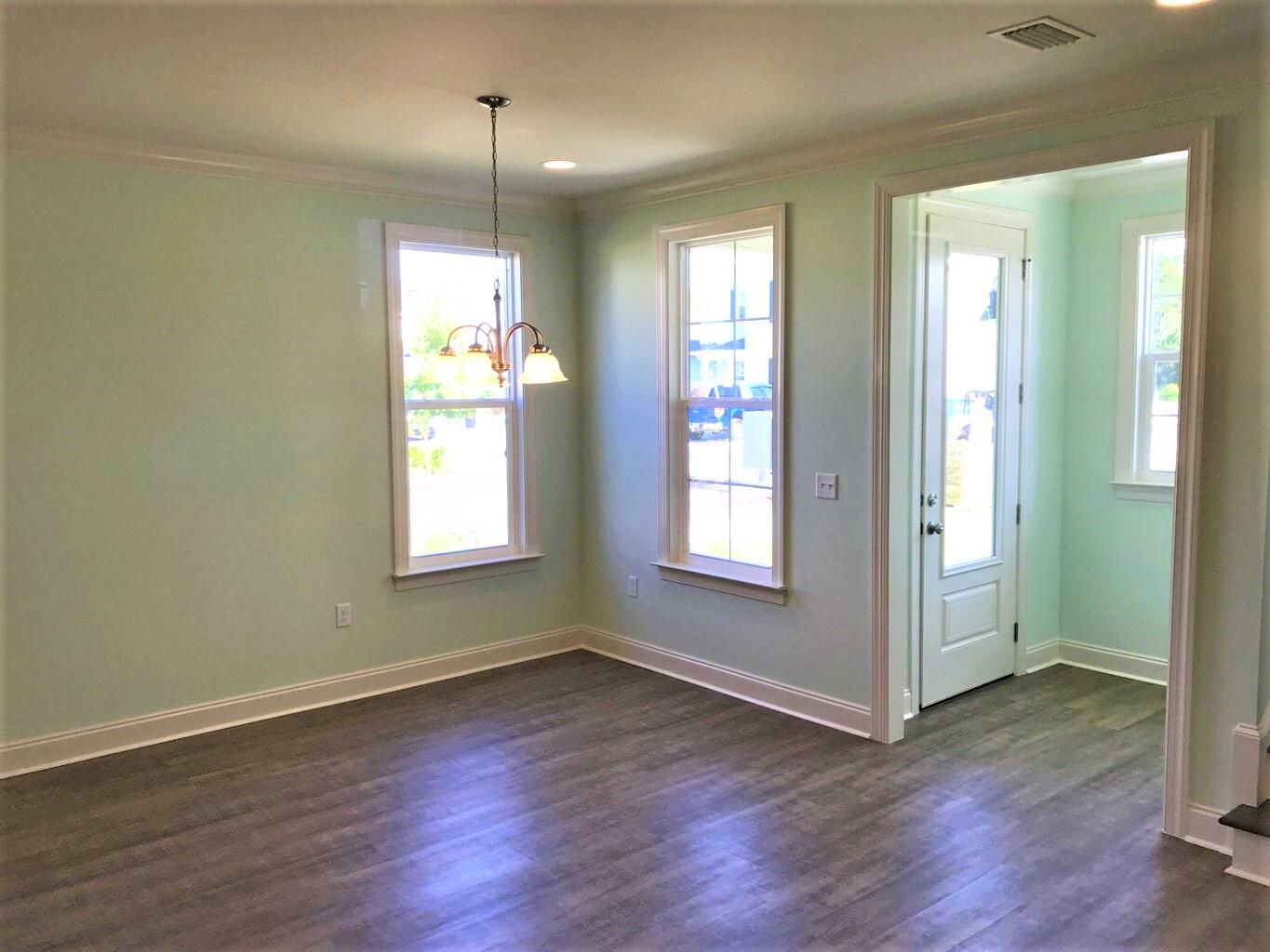 148 Chapman Street Santa Rosa Beach, FL 32459 - Photo 9 of 23 an empty room with wooden floor and windows