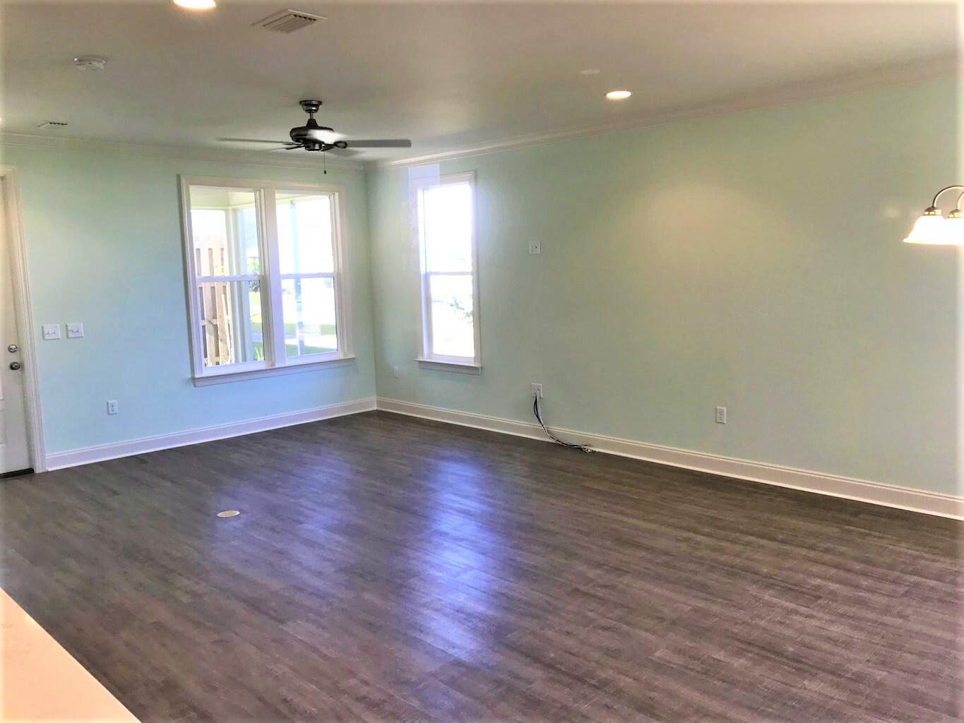 148 Chapman Street Santa Rosa Beach, FL 32459 - Photo 10 of 23 an empty room with wooden floor and windows