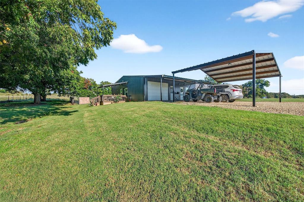 1700 Elmore Road Denison, TX 75021 - Photo 11 of 36 a view of a yard with a house and a garden