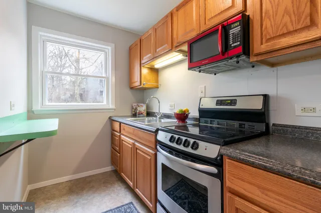a kitchen with stainless steel appliances granite countertop a stove and a microwave