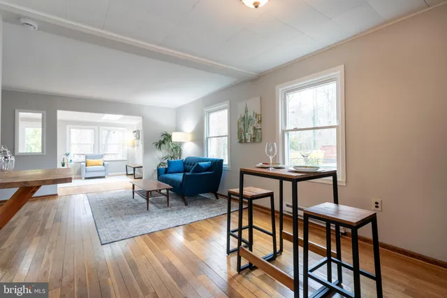 a living room with furniture a window and a table