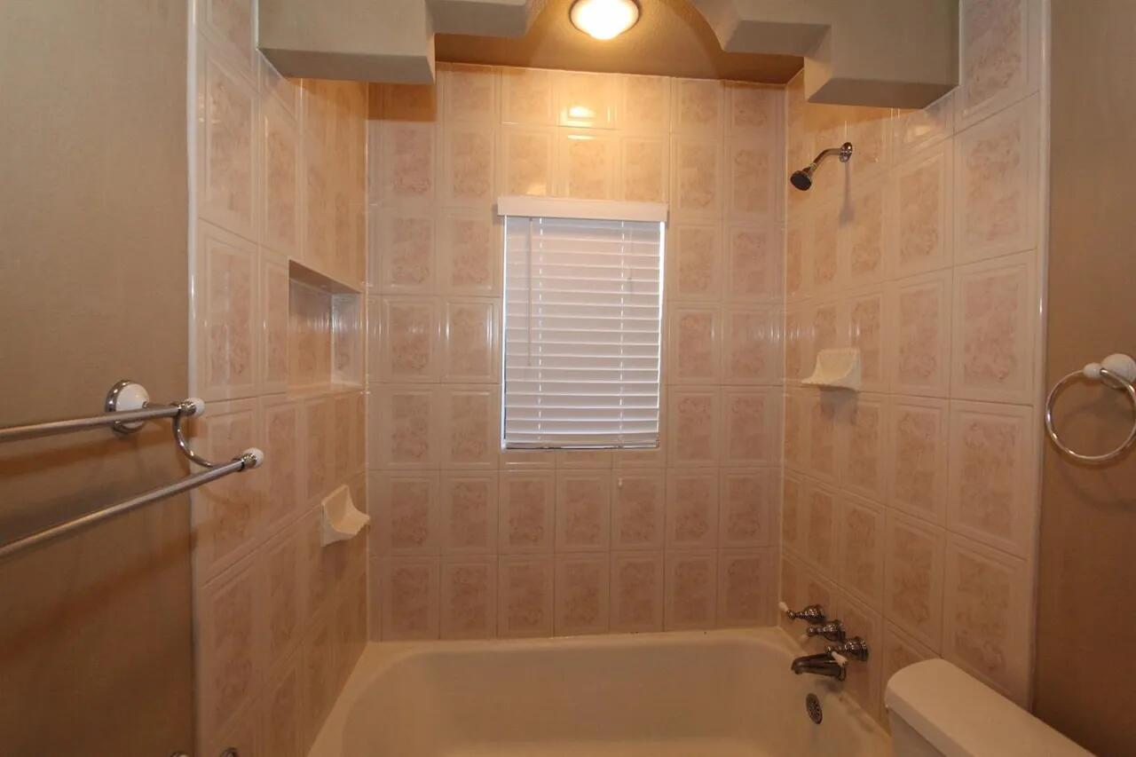 2610 35th Street Lubbock, TX 79410 - Photo 11 of 19 a bathroom with a shower and a toilet
