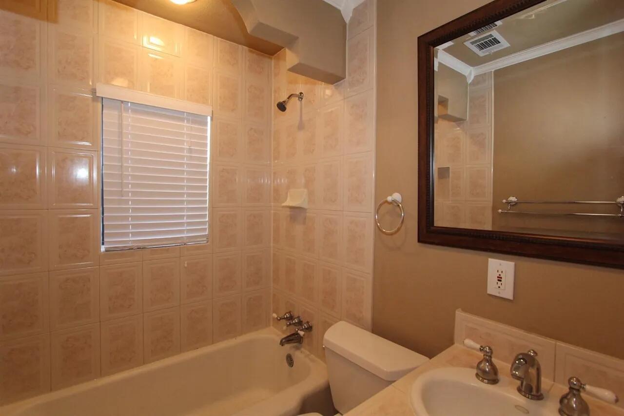 2610 35th Street Lubbock, TX 79410 - Photo 13 of 19 a bathroom with a bathtub and shower