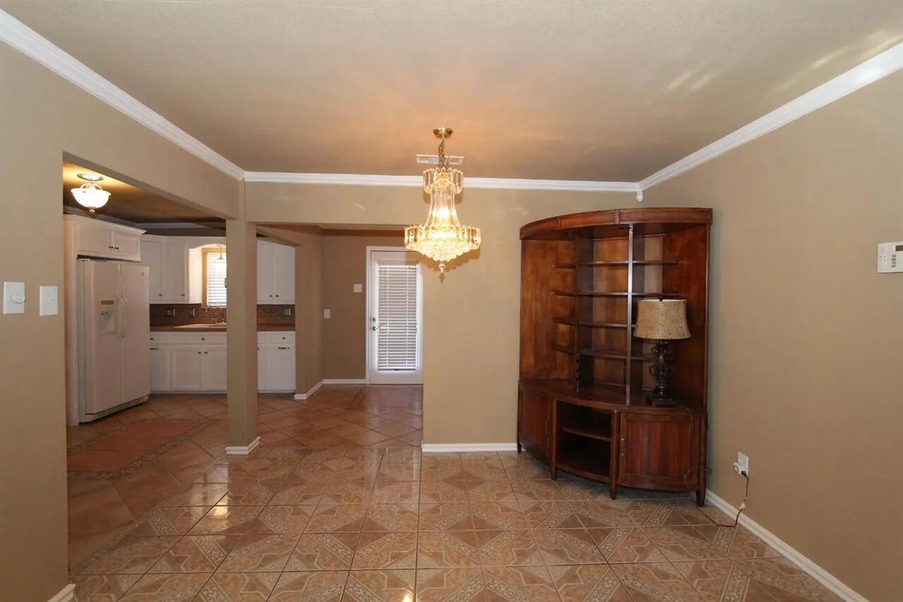 2610 35th Street Lubbock, TX 79410 - Photo 5 of 19 a view of a kitchen with refrigerator and cabinets