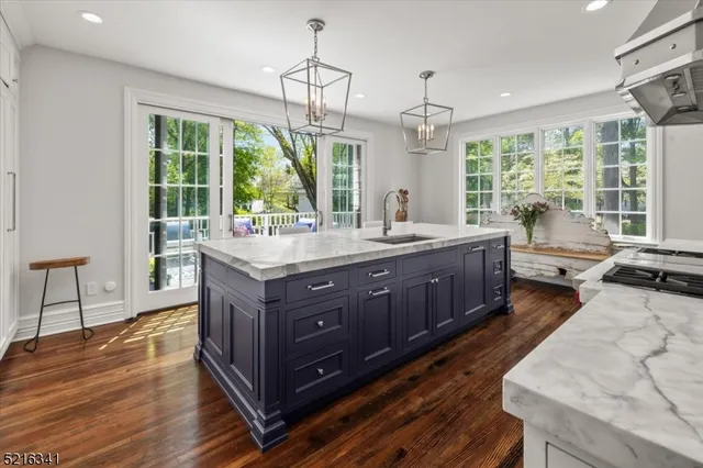 a room with a large window and chandelier