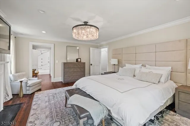 a large bedroom with a bed and a chair