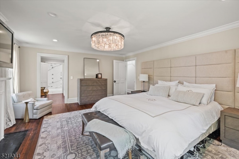 350 South Street, Unit 2 Morristown, NJ 07960 - Photo 20 of 36 a large bedroom with a bed and a chair