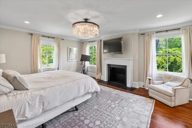 a spacious bedroom with a large bed and a fireplace