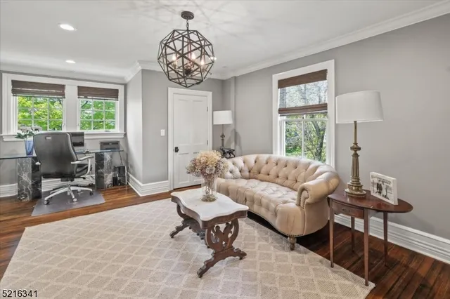 a living room with furniture a dining table and a large window