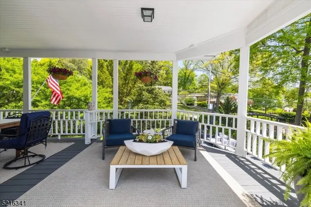 a living room with large windows a table and chairs