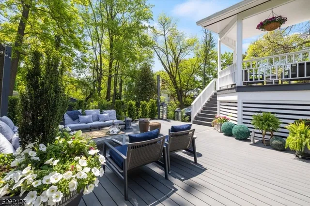 a view of a patio with couches table and chairs and potted plants