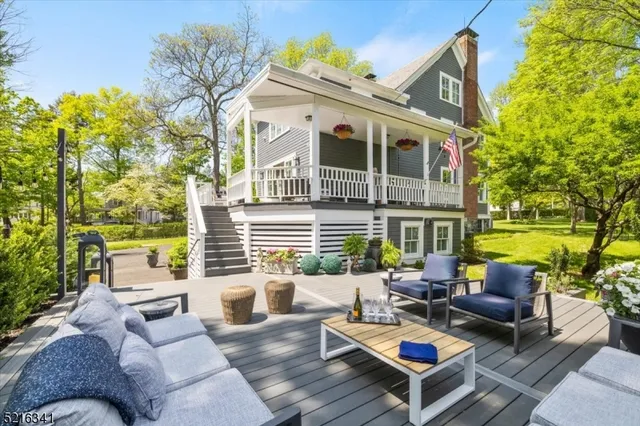 a view of a patio with couches table and chairs and potted plants