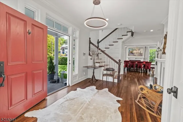 a view of a livingroom with furniture wooden floor windows and a chandelier