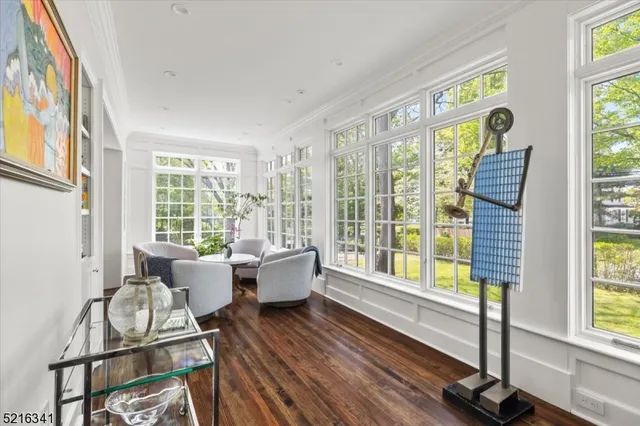 a living room with furniture and floor to ceiling windows
