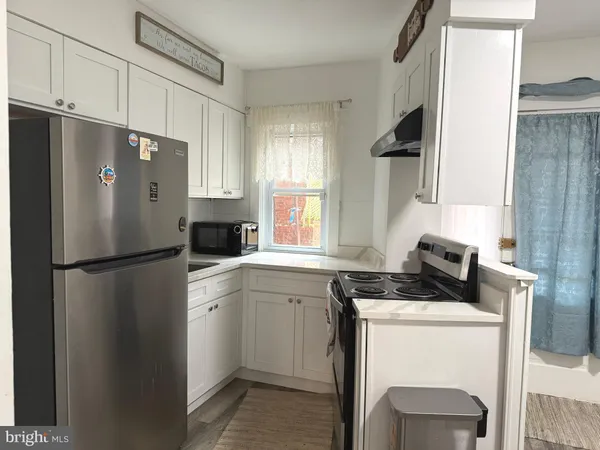 a white refrigerator freezer sitting inside of a kitchen