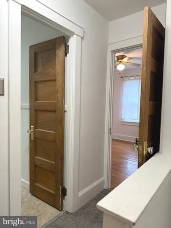 a view of hallway with wooden floor