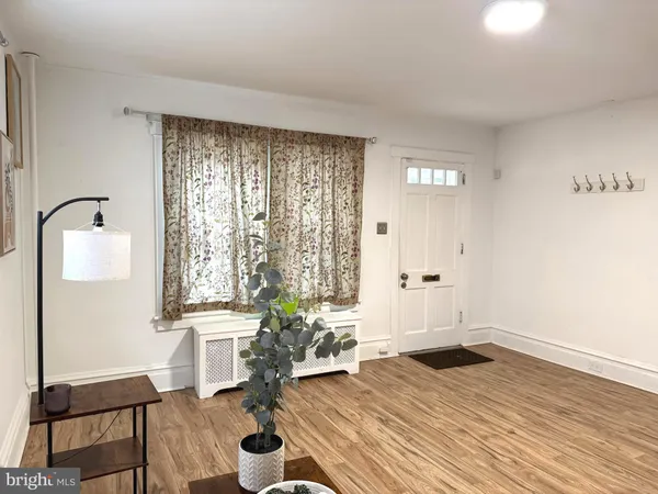 a room with wooden floor and furniture